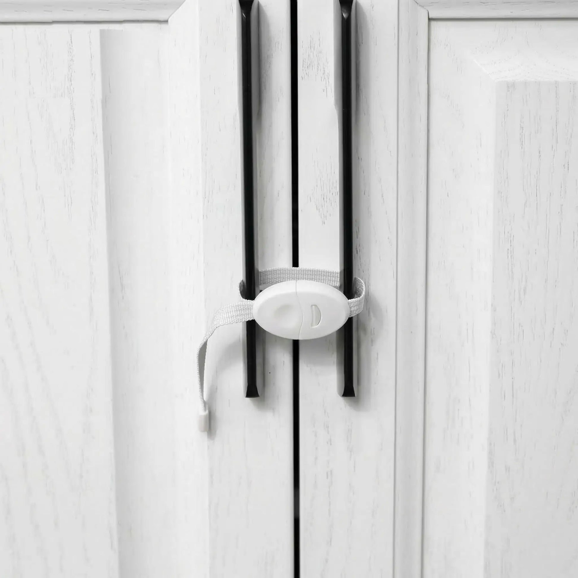 placard-de-securite-bebe-loquet-blanc-sur-poignees-noires-cabinet-blocage-plume-protectrice