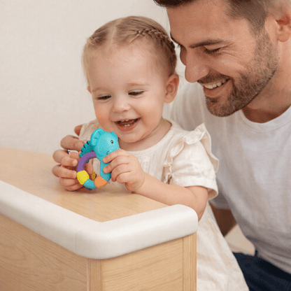 protecteur-de-coin-de-table-bebe-fille-papa-souriant-jouet-babysafetycornerprotector-blanc