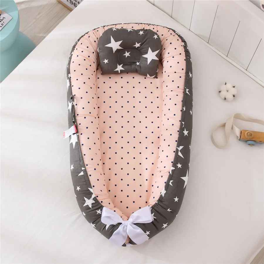 reducteur-de-lit-bebe-etoiles-blanches-sur-fond-noir-inerieur-rose-nidou