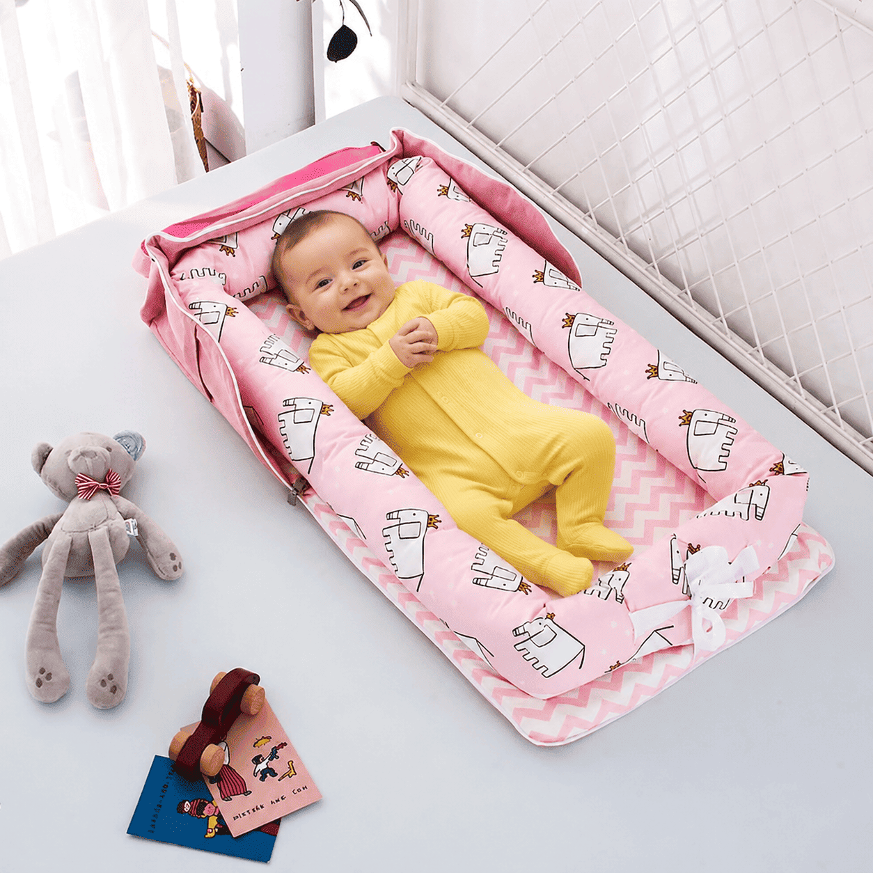 reducteur-de-lit-bebe-nid-rose-confort-dinosaures-jouet-chambre-douceur-nuit-veloutee