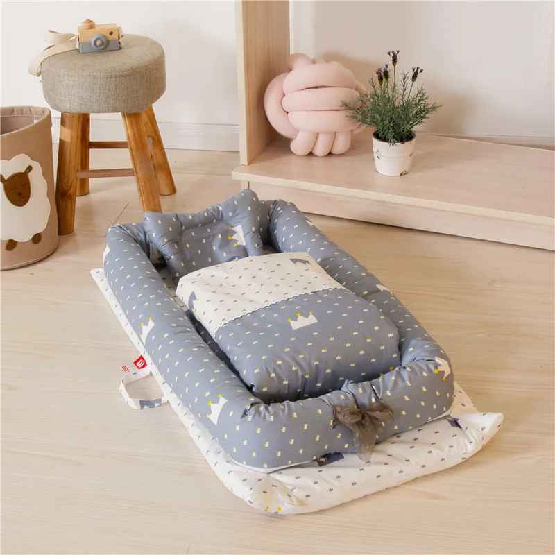 reducteur-de-lit-jollein-nid-bebe-gris-motifs-couronne-confort-nursery-ecrin-de-serenite