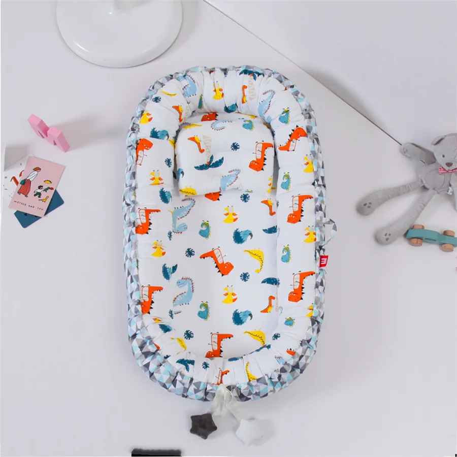 reducteur-de-lit-nid-bebe-dinosaures-couleurs-jouet-peluche-confort-douillet-berceau-tranquille